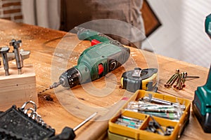 Carpentry workshop drill and other tools lie on the table