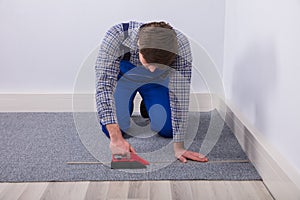 Carpet Fitter Installing Carpet With Wireless Screwdriver