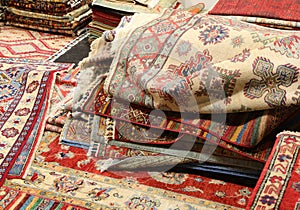 Carpet shop with many wool Persian carpets with colorful geometr