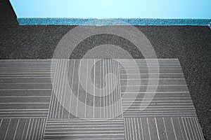 Carpet tiles imbedded into a black carpet