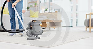 Carpet, vacuum cleaner and a person in the living room of an apartment for hygiene or housework. Cleaning, housekeeping