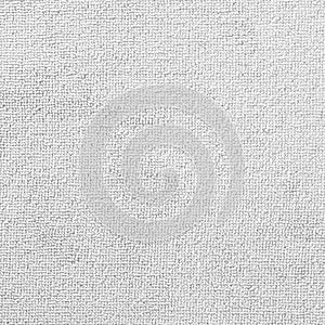 Carpet or white beach towel texture background in beige color made of wool or synthetic fibers, polypropylene
