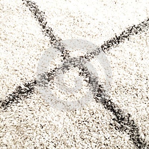 Carpeted white rug with grey stripes squares