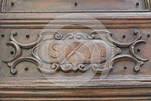 Carrara cathedral, Tuscany Italy. Wood bas-relief on the cathedral`s portal