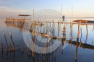 Carrasqueira Palafitic Pier in Comporta, Portugal at sunset.