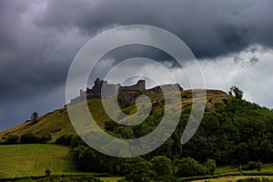 Carreg Cennen castle on a hill. Dramatic sky. Wales, UK