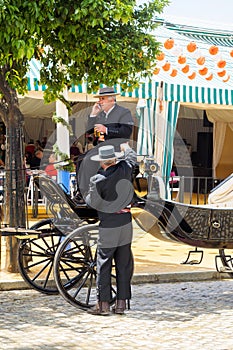 Carriage drivers dressed in tradional traje corto