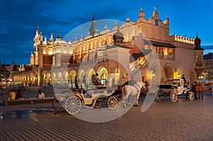 Carriages before the Sukiennice on The Main Market Square in Krakow photo