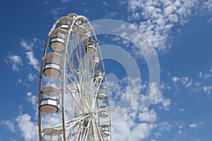 White ferris wheel against a blue sky background