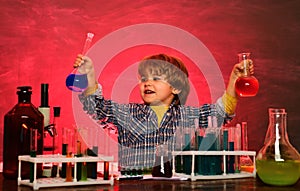 They carried out a new experiment in chemistry. Home schooling. Happy little scientist making experiment with test tube