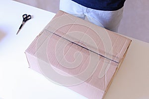 Carrier Checks Packed Boxes, Sealed With Tape on All Sides, Turn