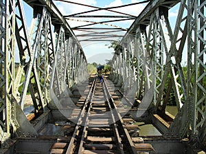 Carriers cross bridge along abandoned railroad, Katanga, Congo