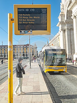 Carris bus 781 in Lisbon approaching the stop with information panel on waiting times.
