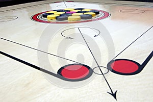 Carrom board with striker and coins photo
