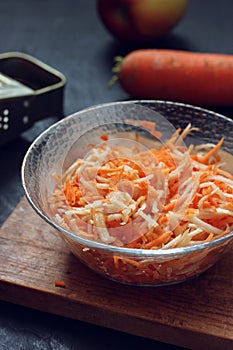 carrot and apple salad in a glass bowl.
