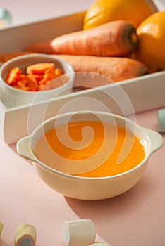 Carrot baby puree in bowl isolated on light background