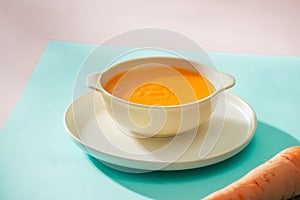 Carrot baby puree in bowl isolated on light background