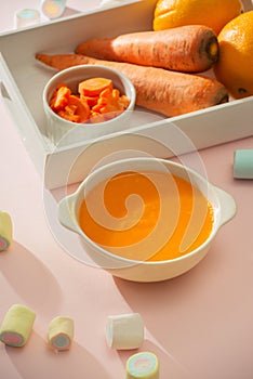 Carrot baby puree in bowl isolated on light background