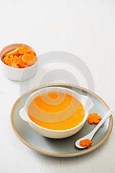 Carrot baby puree in bowl isolated on light background