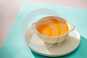 Carrot baby puree in bowl isolated on light background