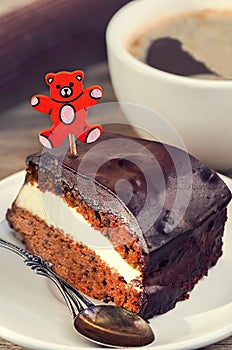 Carrot cake with coffee and teddy bear pick