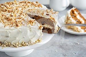 Carrot cake with cream cheese frosting and nuts