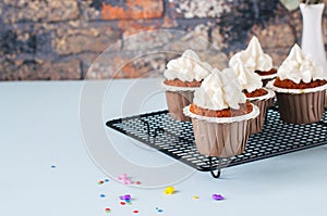 Carrot cake cupcakes with cream cheese frosting with sprinkles