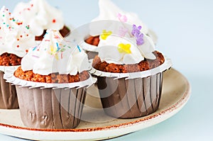 Carrot cake cupcakes with cream cheese frosting with sprinkles