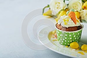 Carrot cake cupcakes for Easter. Carrot cupcakes with cream cheese frosting decorated with tiny marzipan carrots on white backgrou