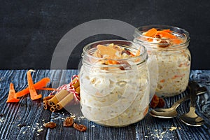 Carrot cake overnight oats in jars on a dark background