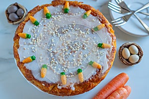 carrot cake pie sprinkled with nuts decorated with cream-colored carrots