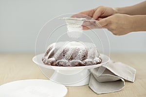 Carrot cake on a stand with powdered sugar. Selective focus