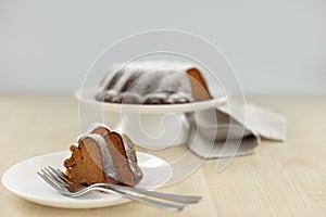 Carrot cake on a stand with powdered sugar. Selective focus