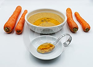 Carrot cream soup vellutata di carote isolated on white background