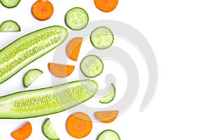 Cucumber and carrot cut sliced isolated on white.