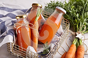 Carrot juice. Fresh organic raw vegetable detox beverage in bottles