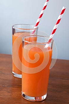 Carrot juice and slices of carrot isolated on white