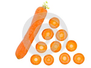 Carrot lies diagonally next to carrot slices on a white isolated background