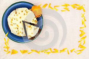 Carrot and marigold cake. Frame,space for text, overhead view.