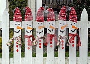 Carrot nose pickets with scarves and Santa stocking caps.