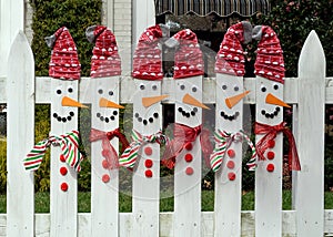 Carrot nose pickets with scarves and Santa stocking caps. photo