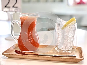 Carrot smoothie in jug drink with ice and lemon, soft drink in beverage and restaurant feeling freshness when drinking, healthy.