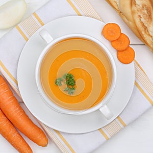 Carrot soup with fresh carrots in bowl from above healthy eating