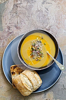 Carrot soup with green sprouts