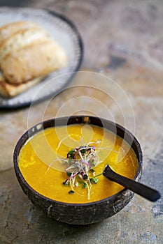 Carrot soup with green sprouts