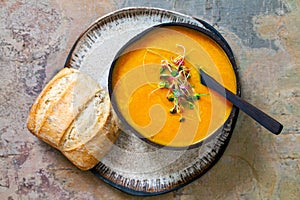 Carrot soup with green sprouts
