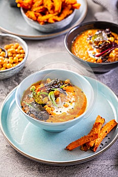 Carrot and sweet potato soup with chickpeas and fresh winter herbs