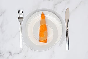 Carrot on a white plate top view