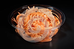 Carrots cut into julienne strips in a bowl