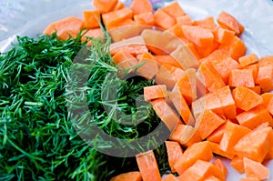 Carrots and dill. Healthy food. Vegetables. Orange and green. Vegetables for proper nutrition. Vegetables on the plates. Diced car